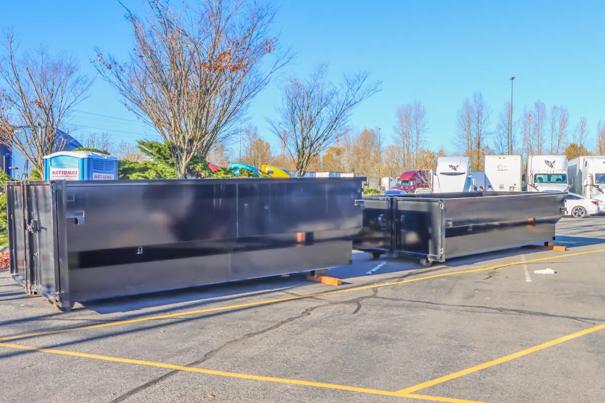 Professional dumpster rental service with roll-off container on residential driveway in Cornelia